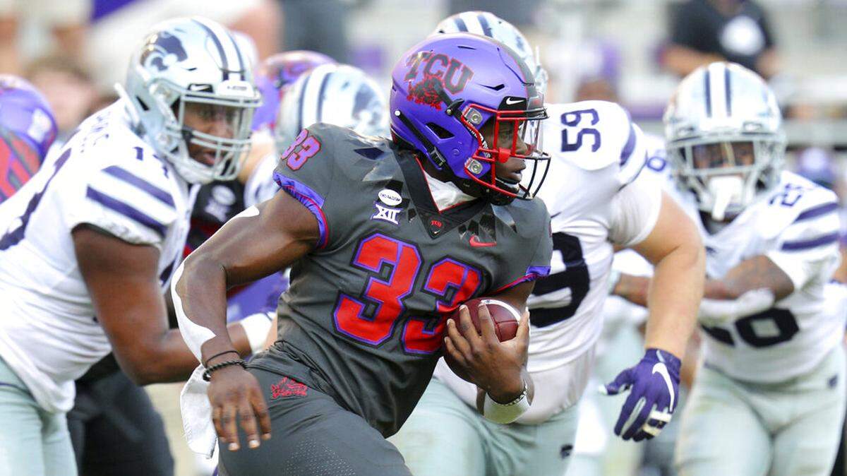 TCU running back Kendre Miller (33) carries the ball against Kansas State in an NCAA college football game Saturday, Oct. 10, 2020, in Fort Worth, Texas. Miller needs to have a big game on the ground for TCU to knock off SMU. (AP Photo/Richard W. Rodriguez)