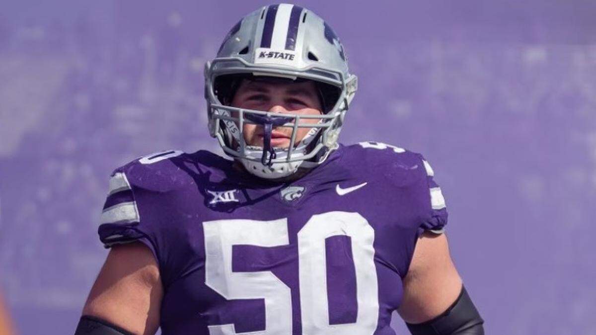 Kansas State offensive lineman Cooper Beebe jogs onto the football field at Bill Snyder Family Stadium.