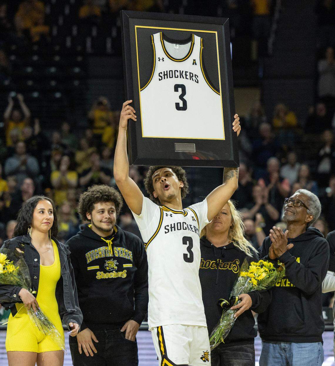 WIchita State senior Craig Porter Jr., celebrates senior day with his family after the Shockers’ defeated South Florida on Sunday.
