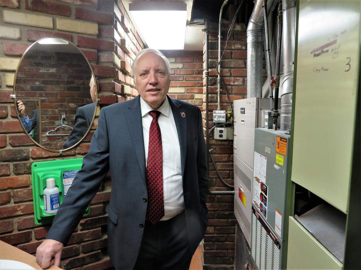 Sedgwick County Commissioner David Dennis stands in the furnace room that doubles as employee bathroom at the Sedgwick County Zoo.