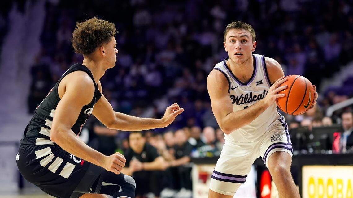 Kansas State Wildcats guard Brendan Hausen (11) looks to pass against Cincinnati Bearcats guard Dan Skillings Jr. (0) during the second half at Bramlage Coliseum. Mandatory Credit: Jay Biggerstaff-Imagn Images