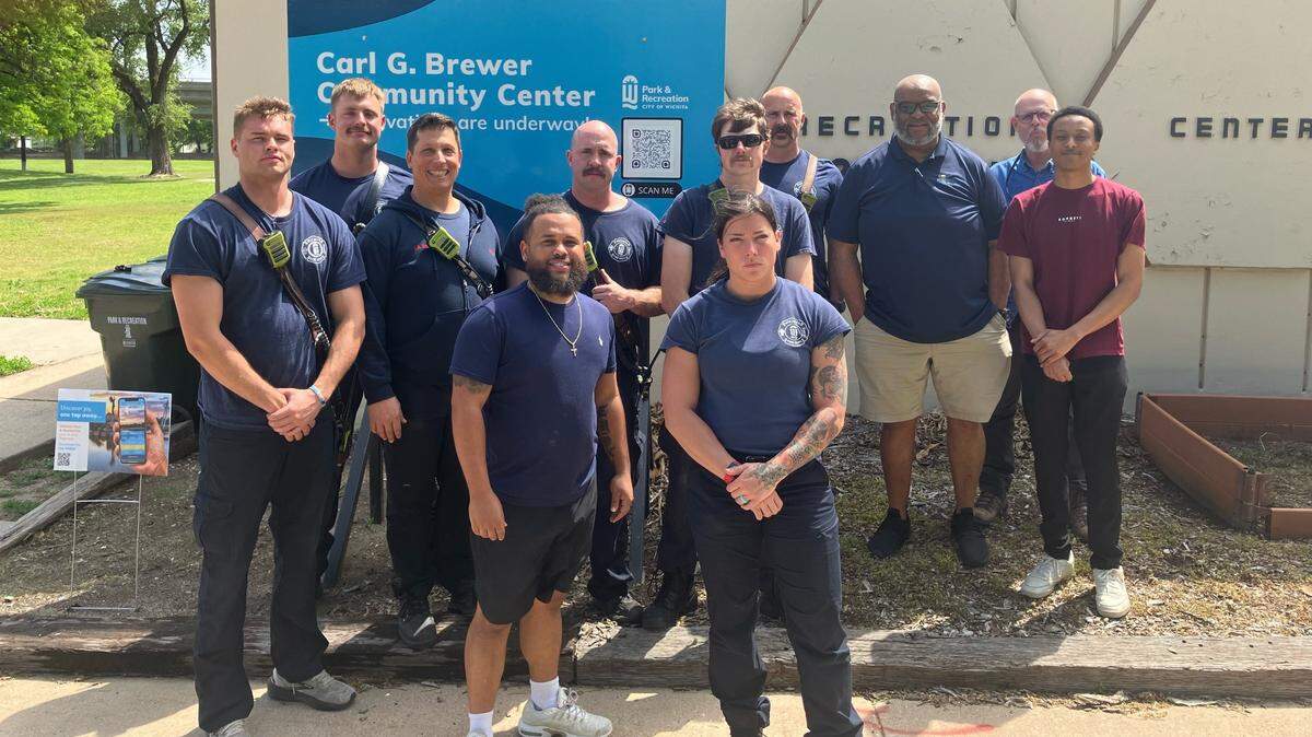 Wichita firefighters pose outside of the Carl G. Brewer Community Center at McAdams Park on April 30, 2024.