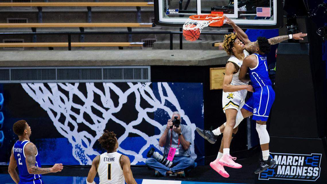 Drake’s Joseph Yesufu (1) dunks on Wichita State’s Clarence Jackson during the first half of a First Four game in the NCAA men’s college basketball tournament Thursday, March 18, 2021, at Mackey Arena in West Lafayette, Ind. (AP Photo/Robert Franklin)