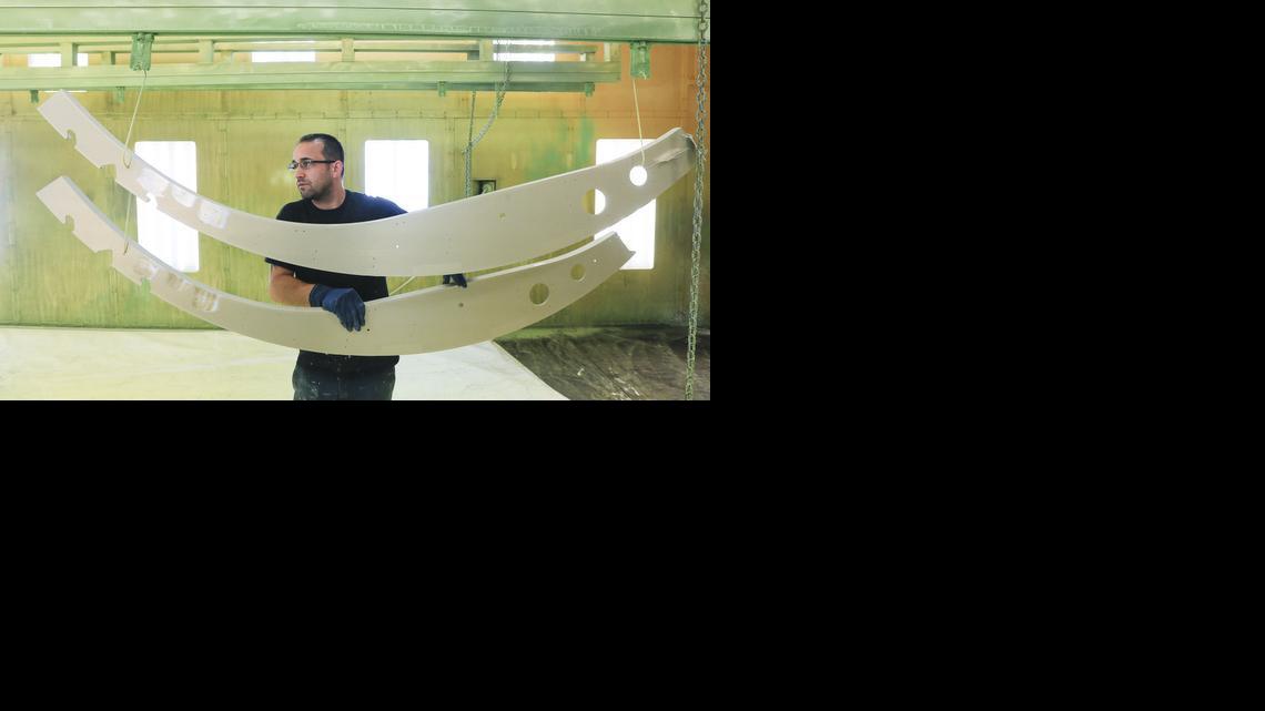 Mark Taylor loads airplane parts into a paint bay at Sonaca NMF. 

