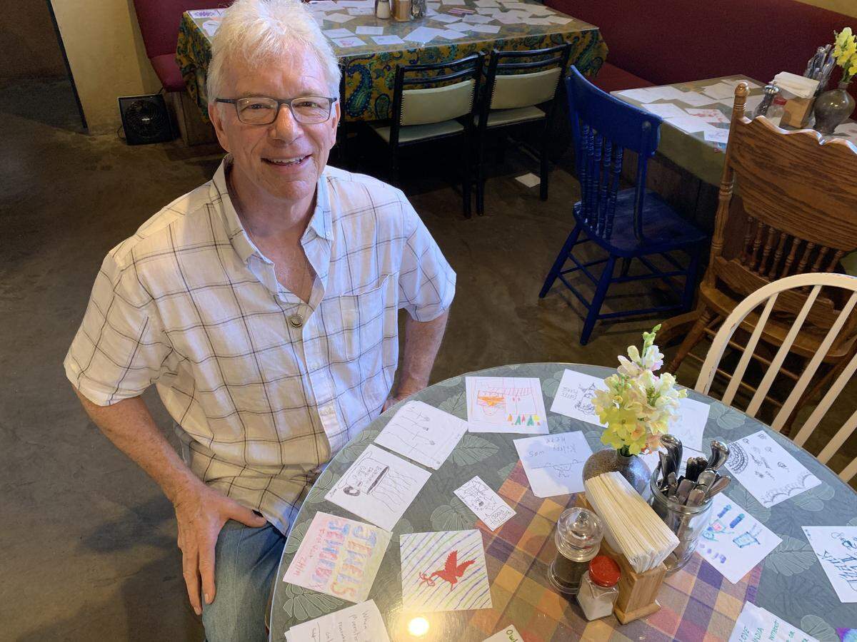 Lincoln Scott, general manager at Beautiful Day Cafe, has become the manager of a spontaneous, ongoing napkin art project by the cafe’s customers.
