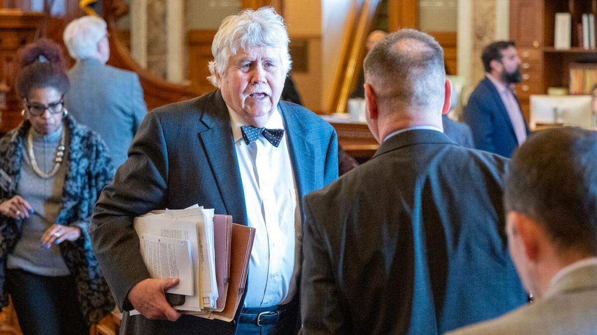 Rep. Henry Helgerson, D-Wichita, warns Kansas House colleagues of the folly of allowing state expenditures to exceed state tax revenue each year by about $500 million. He says burning quickly through cash reserves may trigger a state tax hike in a few years. In this image from Feb. 12, 2026, Helgerson talks to a colleague during a House session.