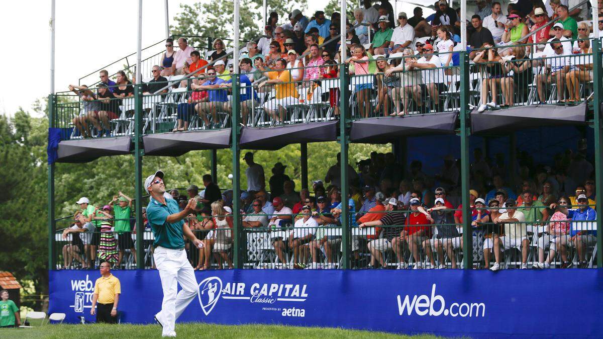 Cameron Percy tosses his ball into the grandstand at the 17th hole. Percy finished the day with a 62 at the Air Capital Classic at Crestview Country Club. (June 22, 2014)
