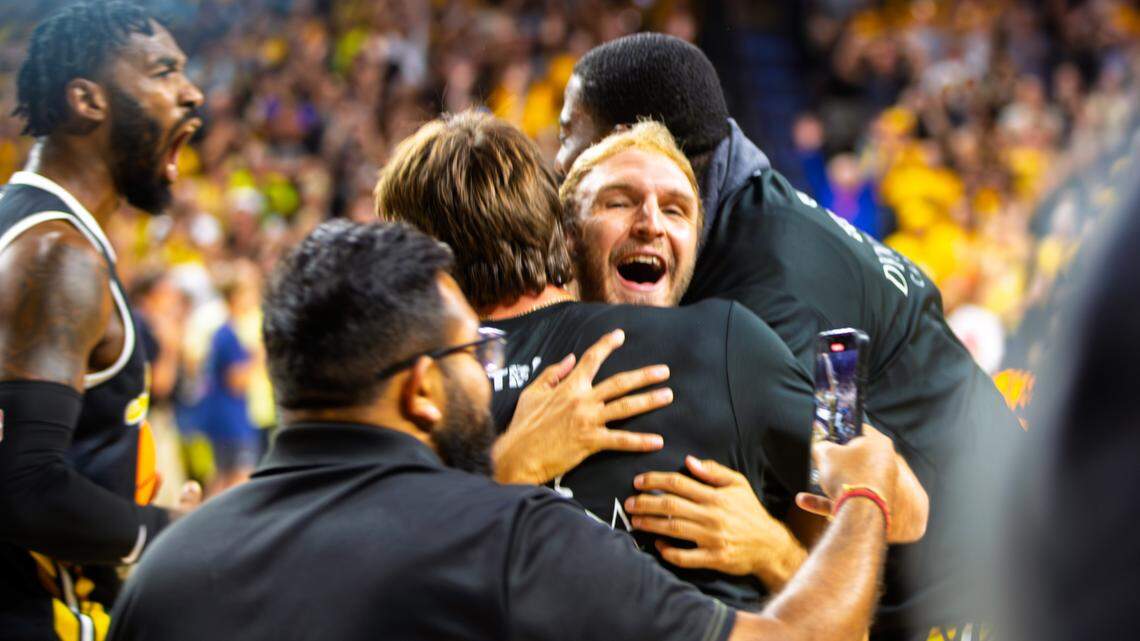 Conner Frankamp hugs an AfterShocks staff member after the team won the TBT championship game on Aug. 3 against Eberlein Drive.