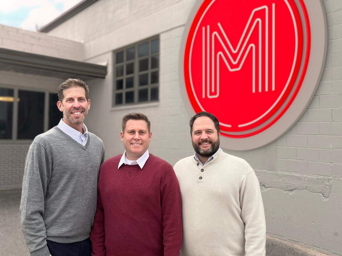 Chris Roth, left, and his cousins, Matt Roth, center, and his brother, Zach Roth, of Miracle Signs this week are buying George Lay Signs and considerably growing their business.