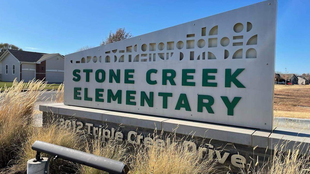A man with a loaded gun was arrested Tuesday morning after he tried to get into Stone Creek Elementary School in Derby, a school district spokesperson said.