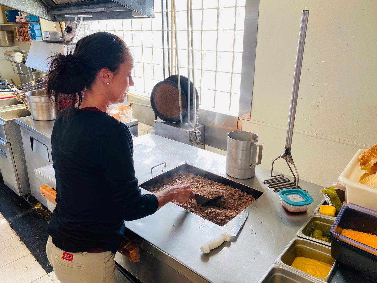NuWay manager Angel Ouellette makes a sandwich in the kitchen at the original NuWay store at 1416 W. Douglas.