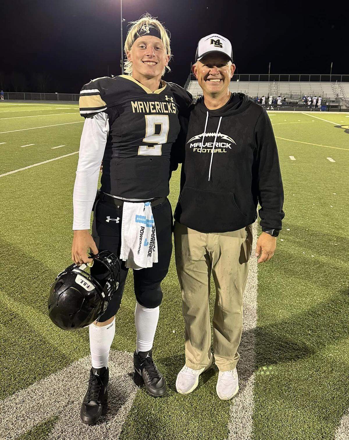 Maize South football coach Brent Pfeifer (right) has known senior quarterback Tate McNew (left) since he was 2 years old. McNew helped Pfeifer win his 100th game as a head coach with the Mavericks last season.