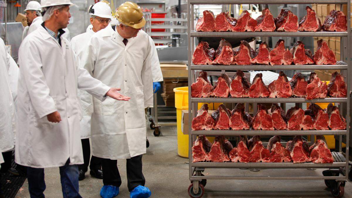 FILE - U.S. Agriculture Secretary Tom Vilsack, center, tours the Greater Omaha Packing beef processing plant in Omaha, Neb., on Nov. 2, 2022. Vilsack sent a letter Wednesday, April 12, 2023, to the 18 largest meat and poultry producers urging them to examine the hiring practices at their companies and suppliers. The letter is part of a broader effort by the Biden administration to crack down on the use of child labor. (AP Photo/Josh Funk, File)