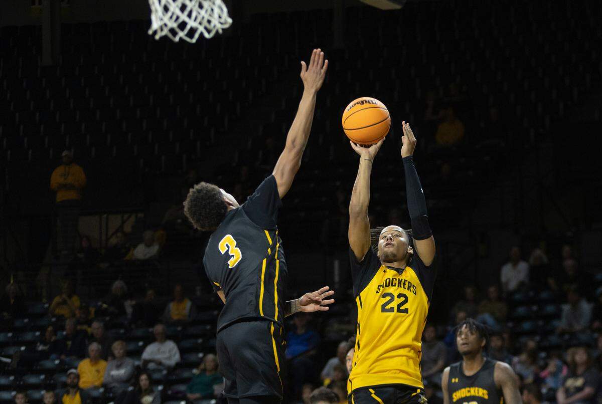 Shammah Scott, right, shoots against Craig Porter, Jr., during the men’s scrimmage at Shocker Madness on Thursday night.