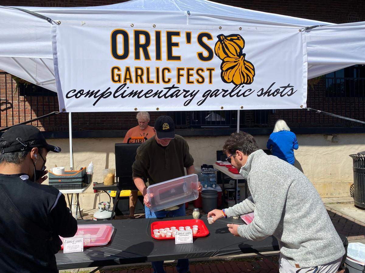 A brave soul helps himself to a garlic shot at the 2022 Orie’s Garlic Fest.