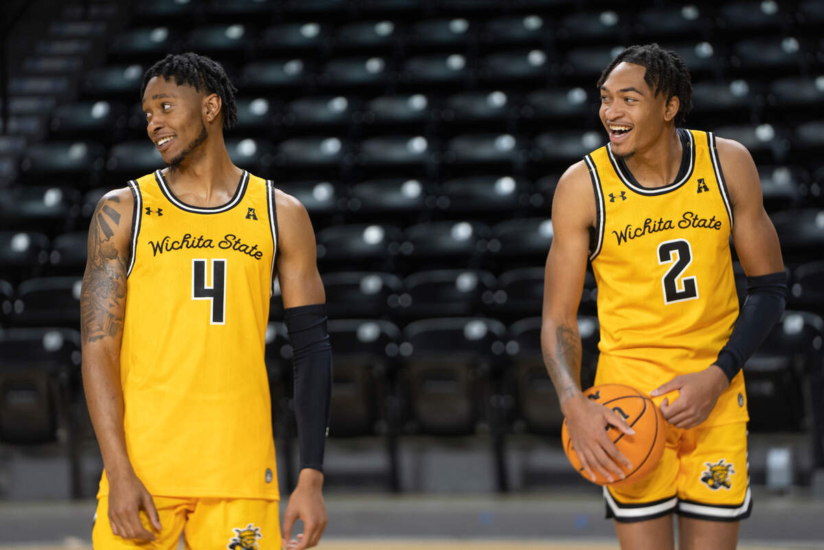 Wichita State Men’s Basketball players Colby Rogers, left, and Jalen Ricks, right, laugh at a teammate during media day.