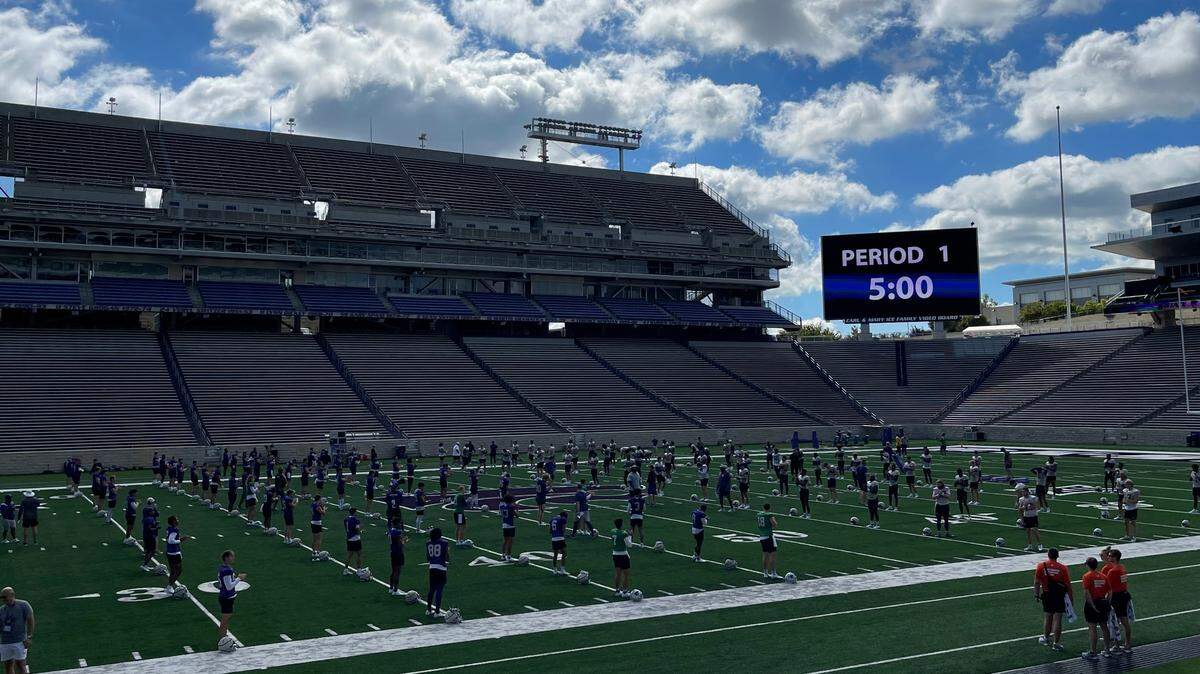 The Kansas State football team warms up for practice at Bill Snyder Family Stadium