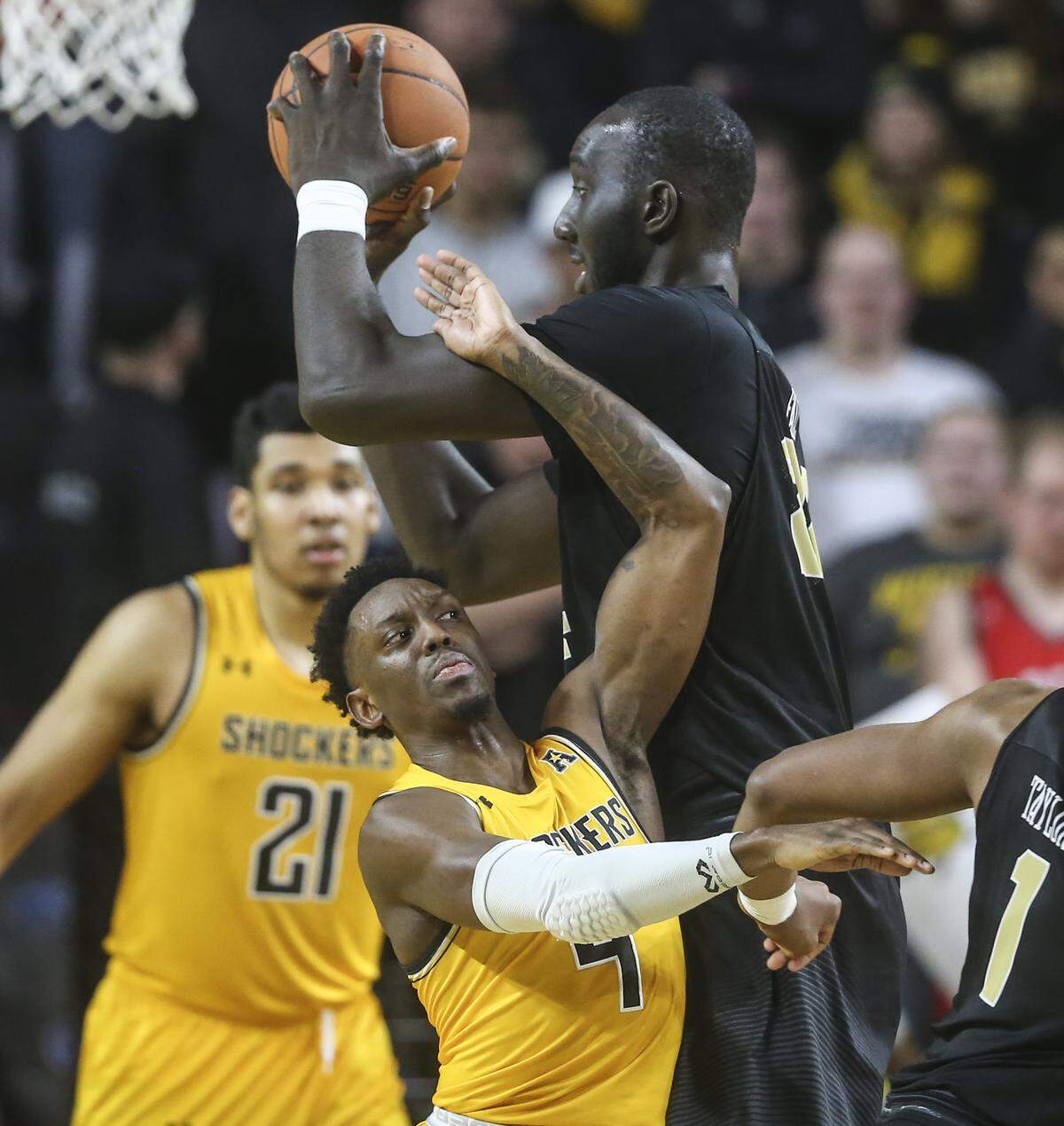 Wichita State guard Samajae Haynes-Jones runs into UCF center Tacko Fall during the second half of their game at Koch Arena on Wednesday.