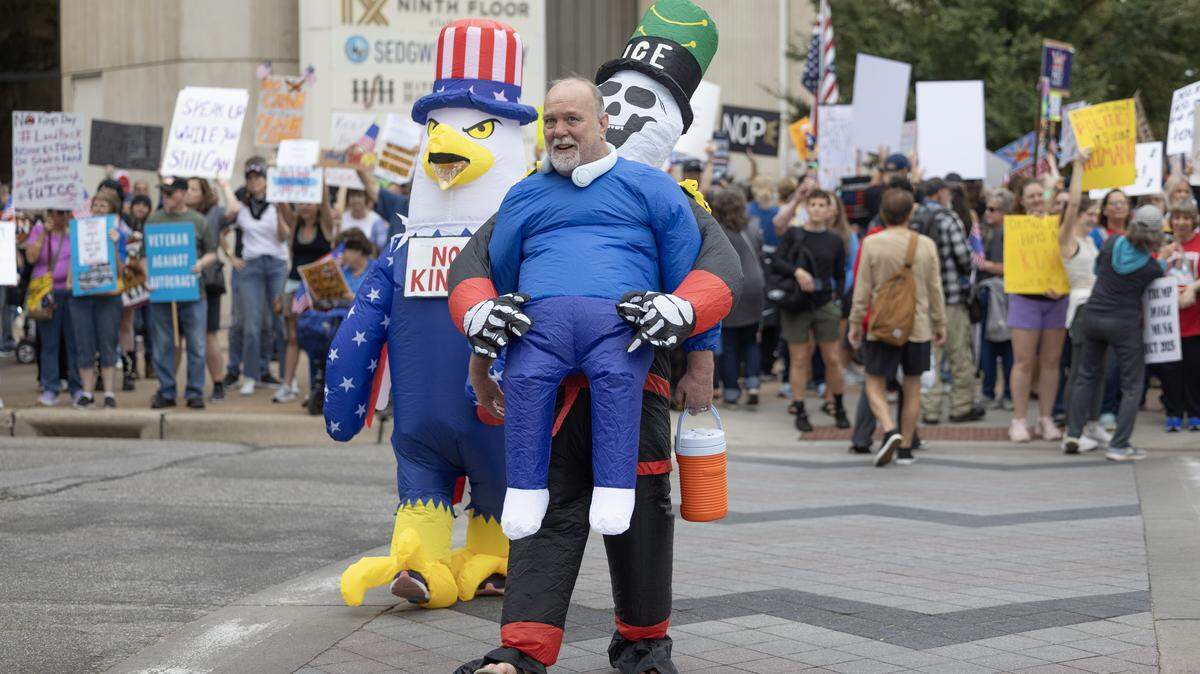 Costumed protesters take part in the national “No Kings” protest in Wichita on Oct. 18.