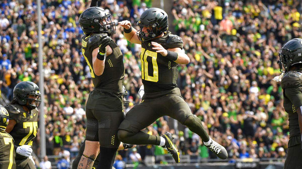 Oregon quarterback Bo Nix (10) celebrates a touchdown against BYU with Oregon tight end Terrance Ferguson during the first half of an NCAA college football game, Saturday, Sept. 17, 2022, in Eugene, Ore. (AP Photo/Andy Nelson)