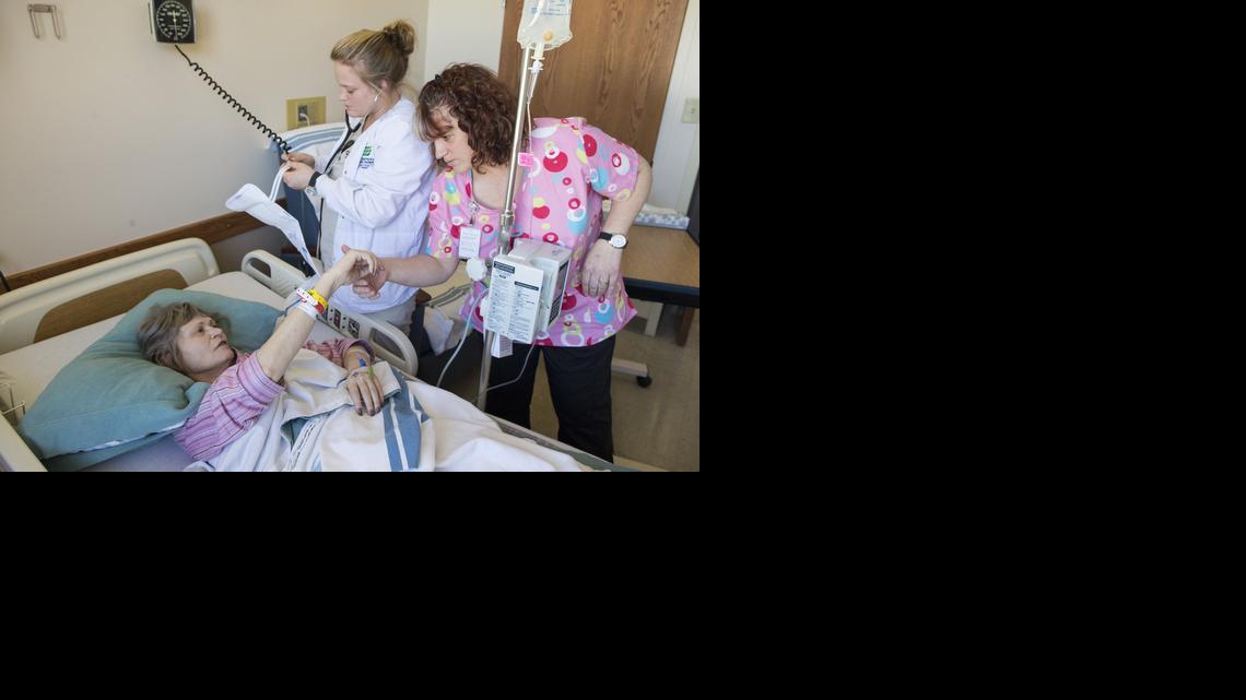 Jarjean Ford is cared for by nursing student Shaneese Wedman, middle, and Shondra Kostner, RN, at the Kingman Community Hospital. A change in designation could cut funding for the state’s critical access hospitals.

