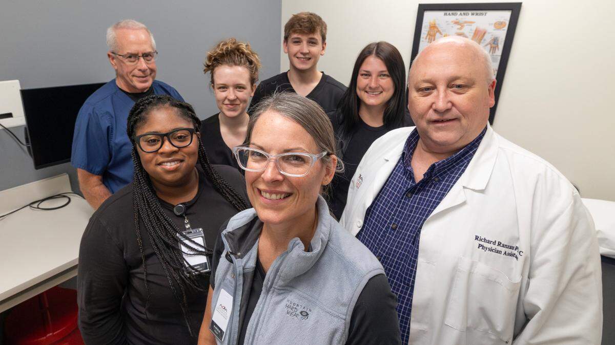 Kara Cox, front, and Colin Lisenby, not pictured, will run the new AOA NOW- Orthopedic Immediate Care within the new Advanced Orthopaedic Associates office. Some of their staff members include, from left, physician assistant Steve Montague, nurses Samantha Scott, Alexis Query, Ryan Ranzau, Kayla Marshall and physician assistant Richard Ranzau.