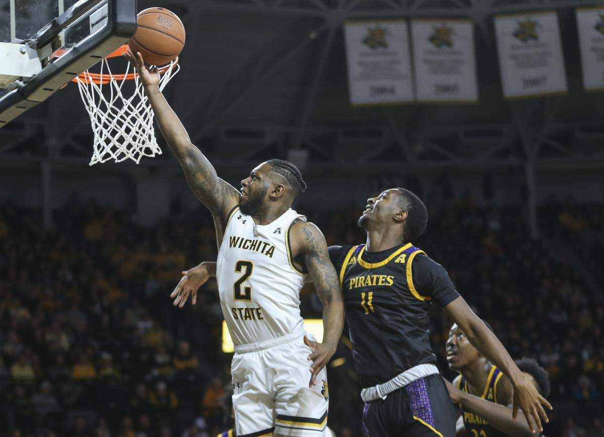 Wichita State’s Jamarius Burton makes a layup against East Carolina’s JJ Miles during the first half of their game at Koch Arena on Wednesday.