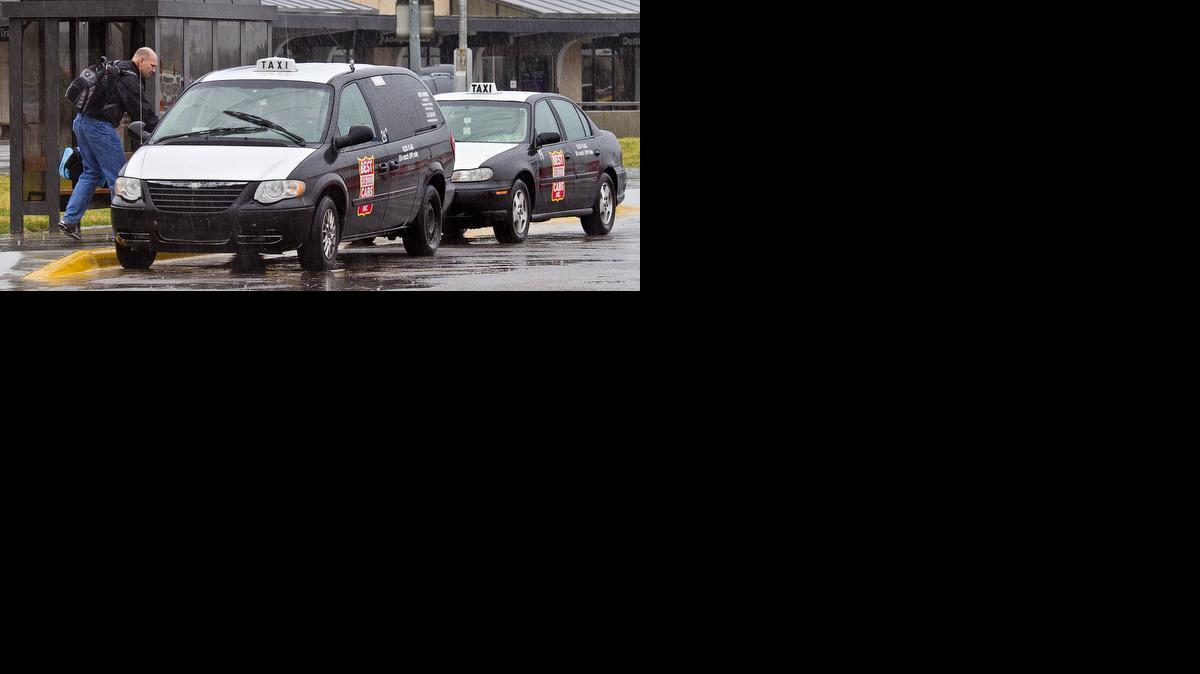 Taxicabs pick up passengers at Wichita Mid-Continent Airport. (March 19, 2012)

