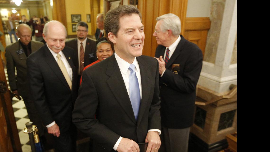 Gov. Sam Brownback is announced Tuesday night prior to the State of the State address. Accompanying the governor was Sen. Oletha Faust-Goudeau, D-Wichita, (right) and Sen Les Donovan, R-Wichita. (Jan. 15, 2013)
