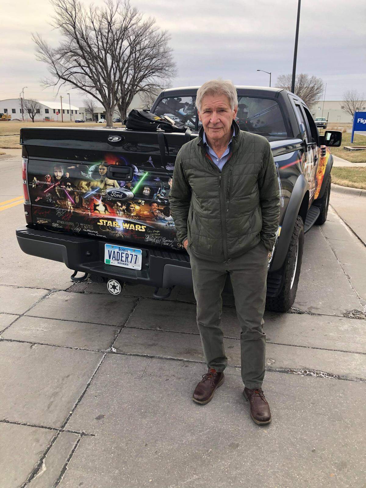 Harrison Ford poses in front of a tricked out “Star Wars” truck owned by Iowa resident Trey Laymon, who tracked Ford to Wichita to get his autograph.