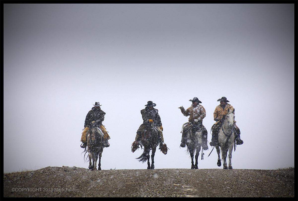 Josh Hoy, right, and other men ride through the snow in 2013.