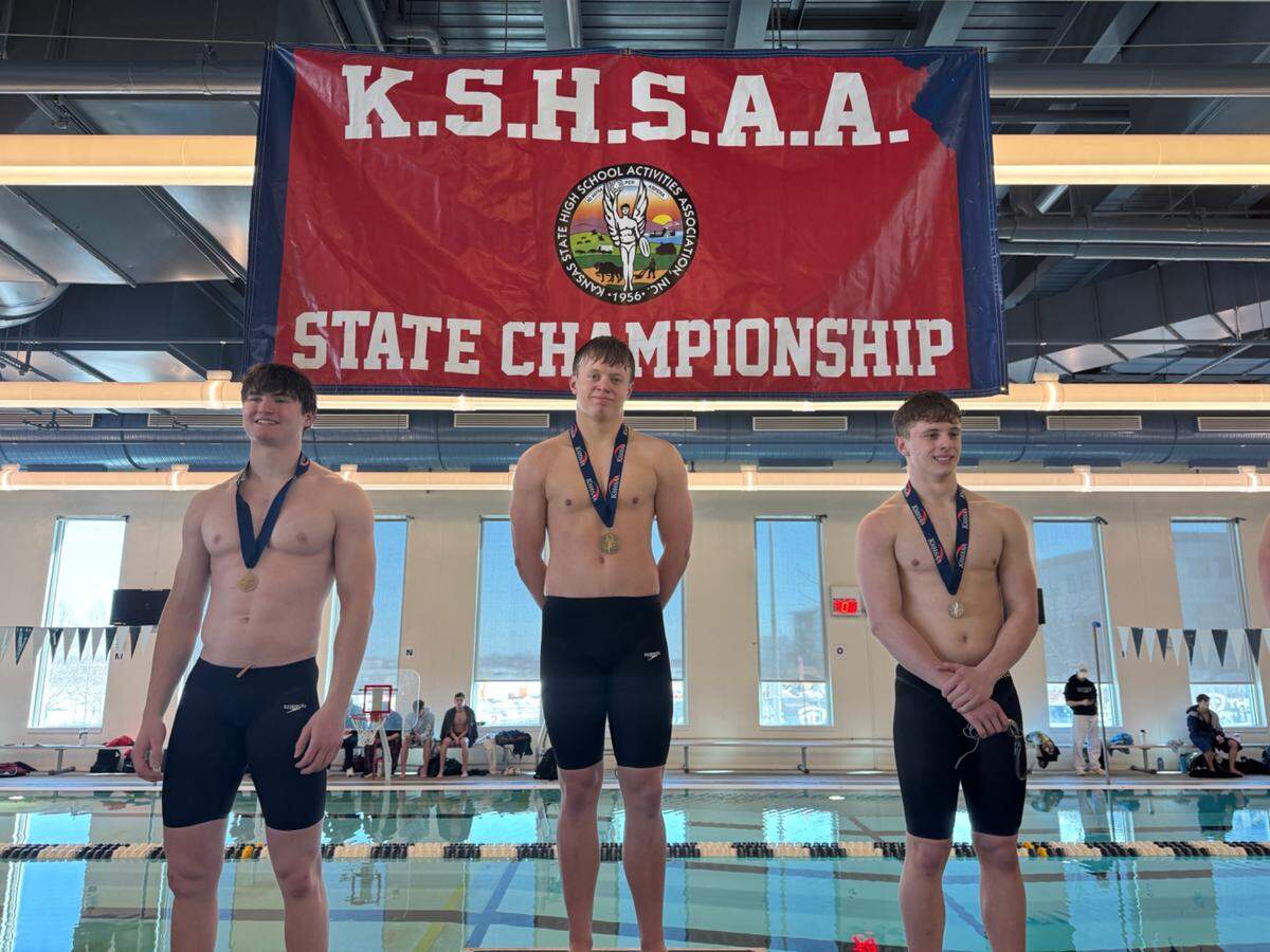 Maize junior Zach Rife (middle) won a pair of gold medals at the Kansas high school boys swimming state championship meet over the weekend.