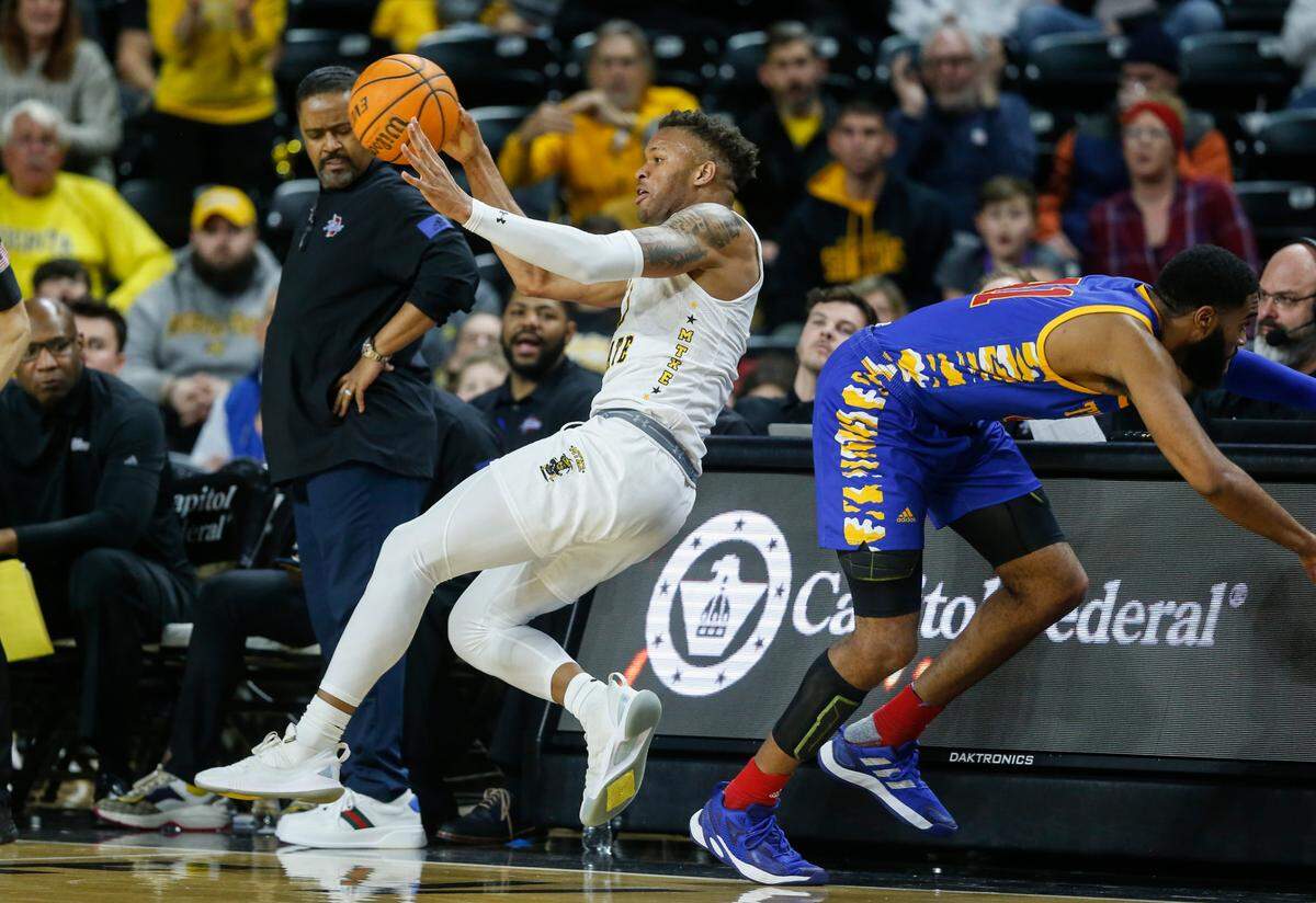Wichita State’s Dexter Dennis saves the ball from going out of bounds while getting a steal during the second against Tulsa on Tuesday night at Koch Arena.