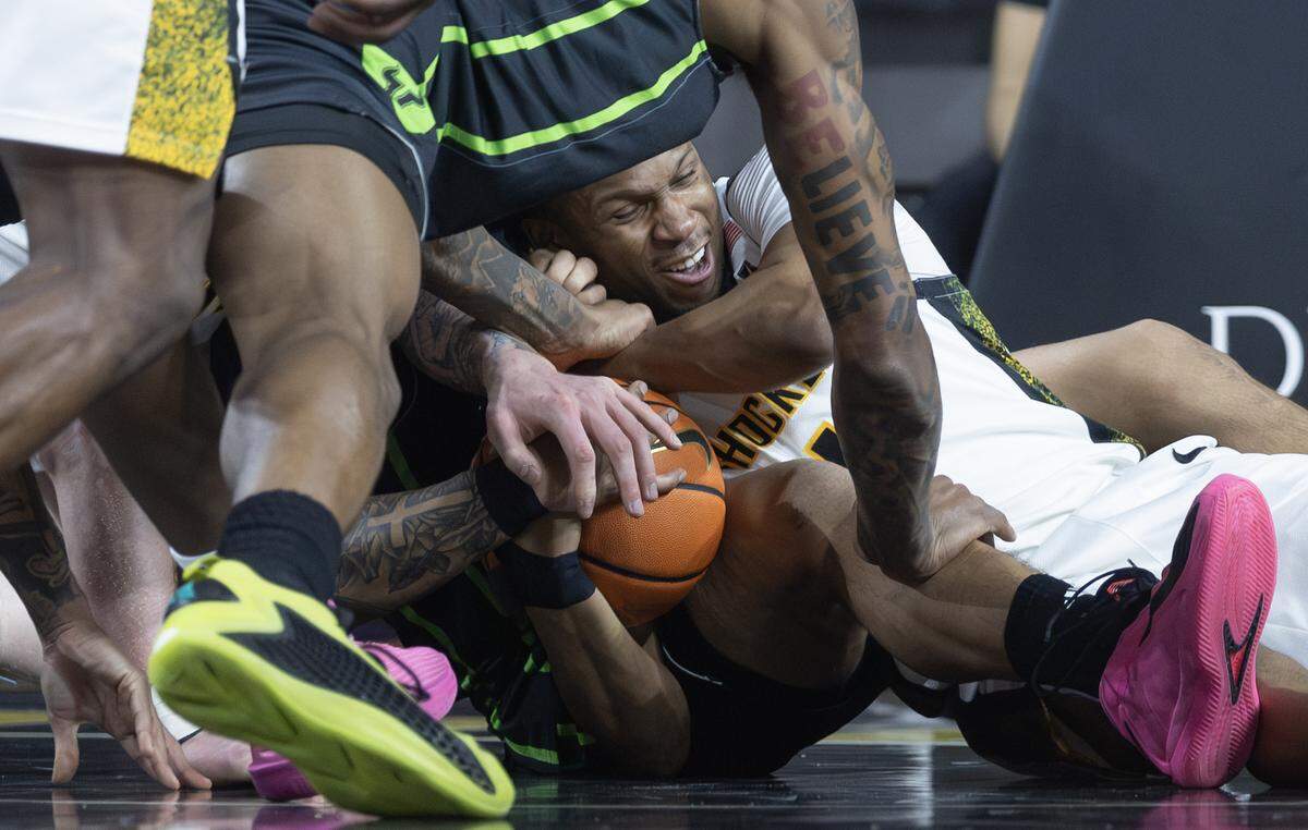 Wichita State’s Kenyon Giles fights for the ball during the first half against South Florida at Koch Arena on Wednesday night. 