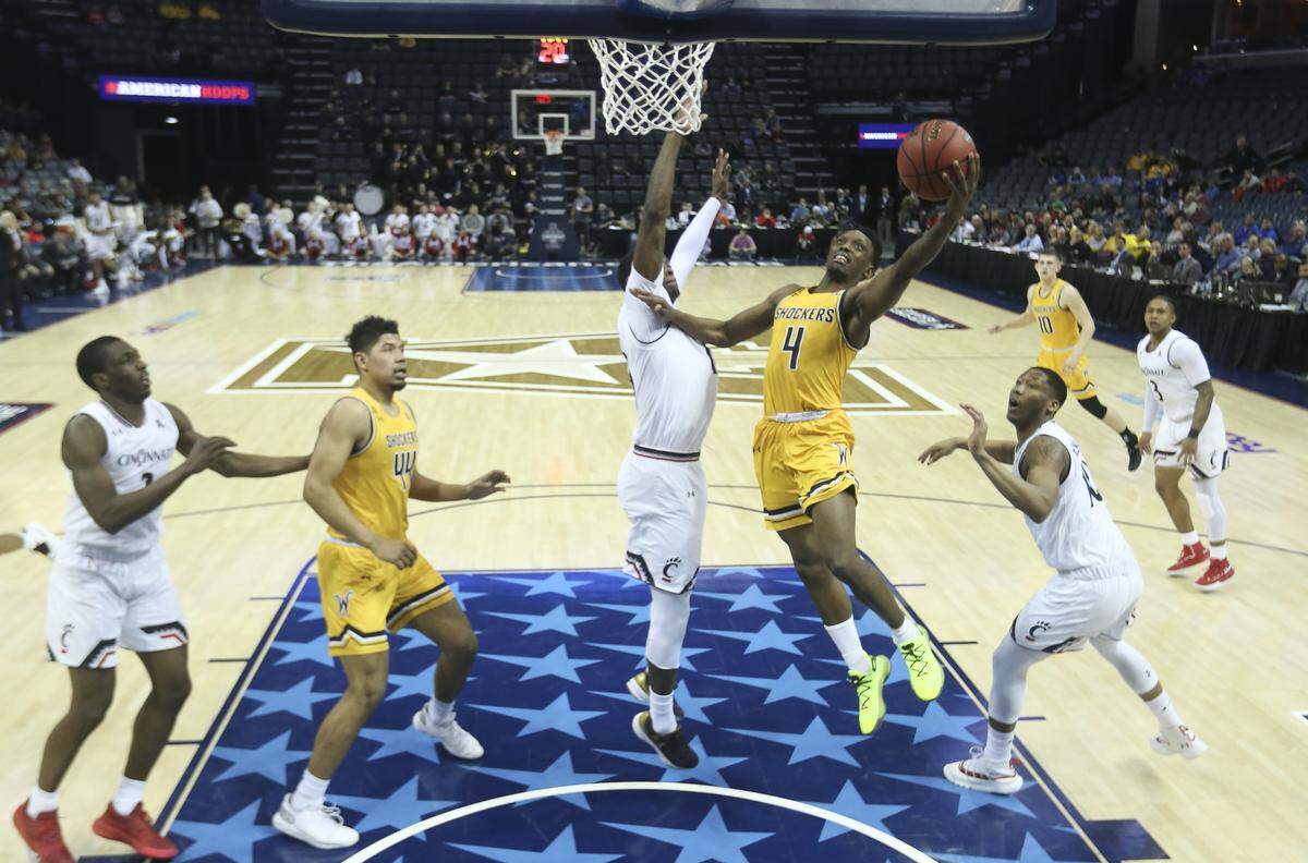 Wichita State guard Samajae Haynes-Jones makes a layup against Cincinnati forward Tre Scott during the second half of their American Athletic Conference semifinal game in Memphis on Saturday.
