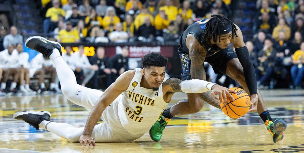 Wichita State’s Ronnie DeGray III dives for a loose ball against Memphis’ Colby Rogers during the second half at Koch Arena earlier this season. 
