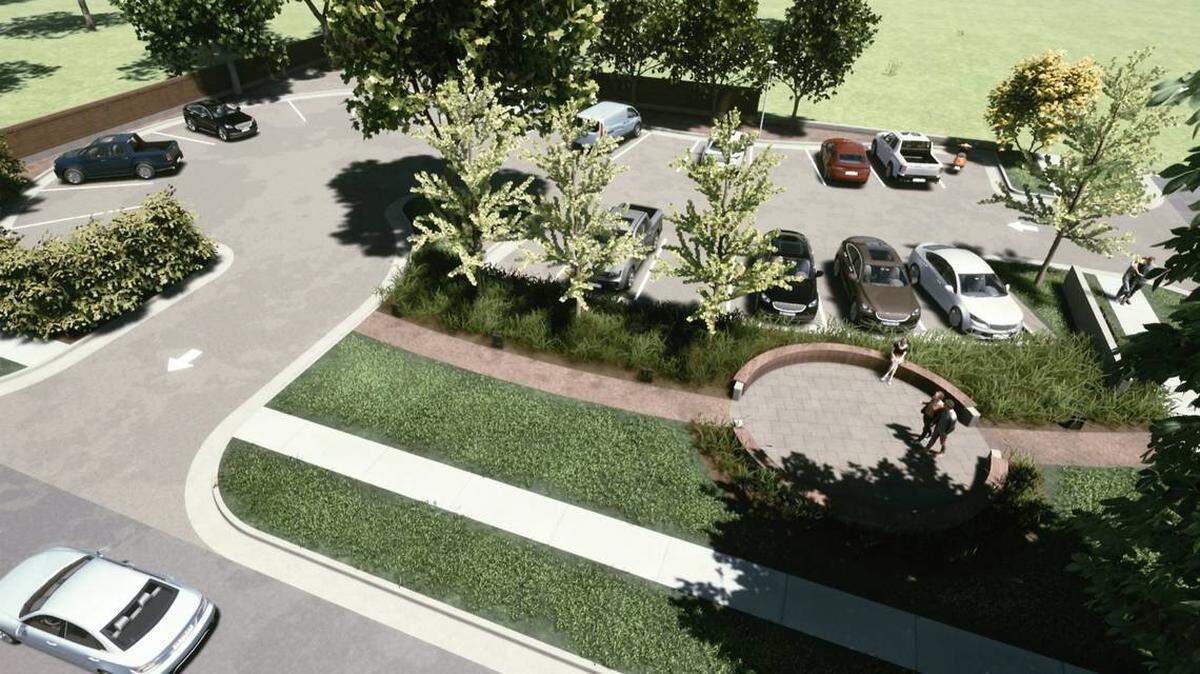 This is an aerial view, including a walking path and circular bench, of the parking lot the Happiness Plaza owners want to build after demolishing houses near the development.