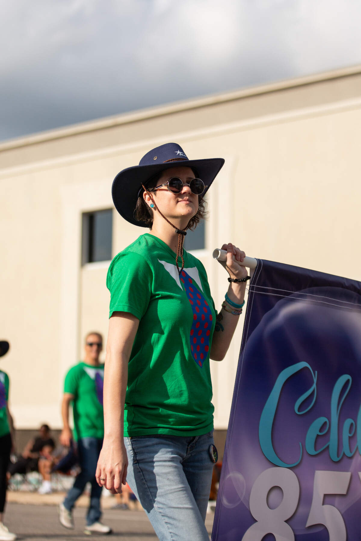 Riverfest volunteers and members walk down Main during the Star Lumber Sundown Parade on the first night of Riverfest.