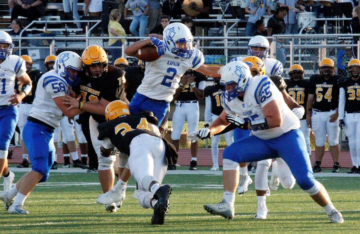 Kapaun senior running back Jacob Nye fights for extra yardage during the Crusaders’ 26-3 victory against Wichita Southeast in their season opener.