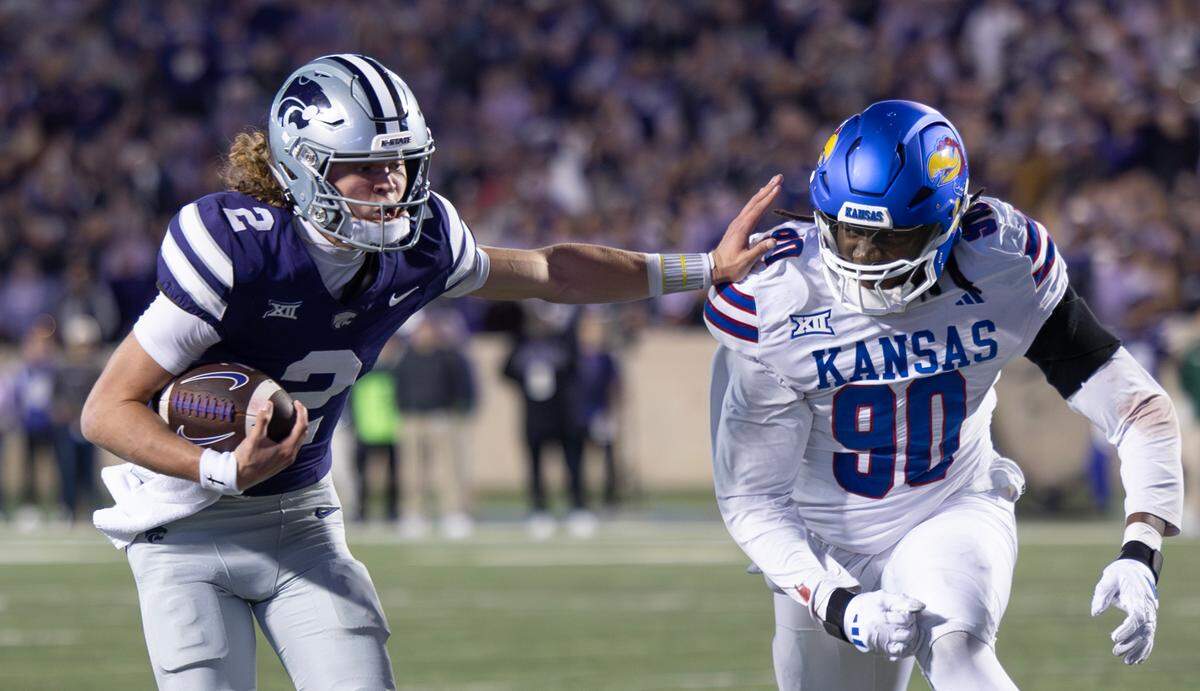 Kansas State’s Avery Johnson outruns Kansas D-lineman Jereme Robinson on his way to a touchdown at Bill Snyder Family Stadium.