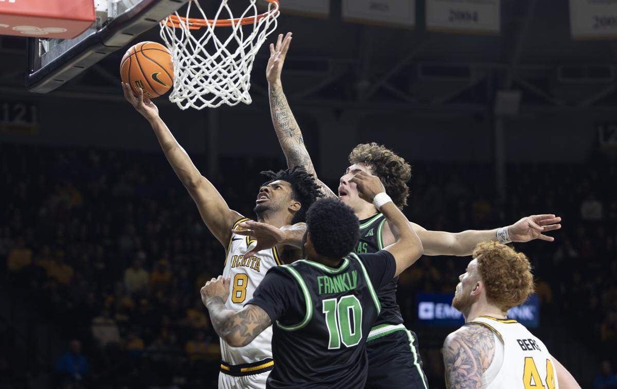 Wichita State’s Dillon Battie goes to the basket through two North Texas defenders on Sunday during their game at Koch Arena.