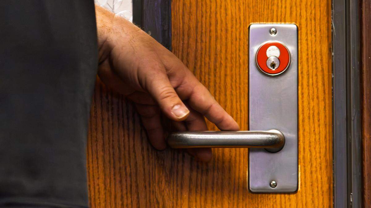 Hamilton Middle School Principal Chad Cushenbery shows how to use a red lock and door. A red key enables a Hamilton faculty member to lock any red door in the school.