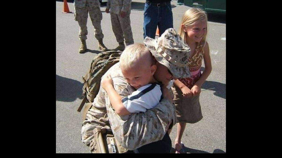 William Murphy embraces his children after arriving back from Iraq to stateside in 2006. He lost most of his vision just a couple weeks later.