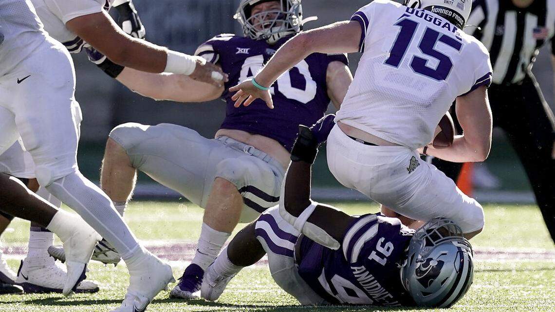 TCU quarterback Max Duggan (15) is sacked by Kansas State defensive end Felix Anudike-Uzomah (91) during the first half of an NCAA college football game, Saturday, Oct. 30, 2021, in Manhattan, Kan. (AP Photo/Charlie Riedel)