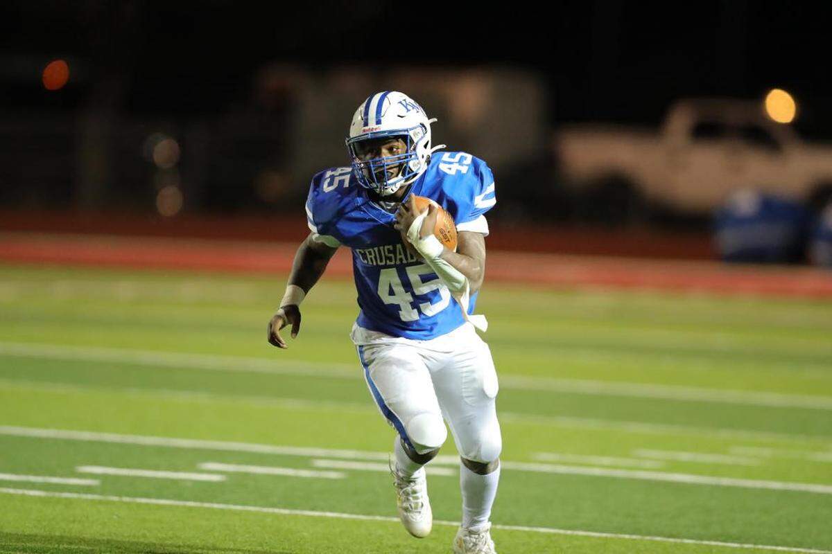Kapaun Mt. Carmel sophomore running back Omari Elias runs for one of his three touchdowns in the Crusaders’ 38-35 victory over Wichita Northwest on Friday.