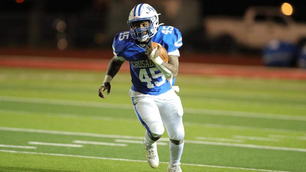 Kapaun Mt. Carmel sophomore running back Omari Elias runs for one of his three touchdowns in the Crusaders’ 38-35 victory over Wichita Northwest on Friday.