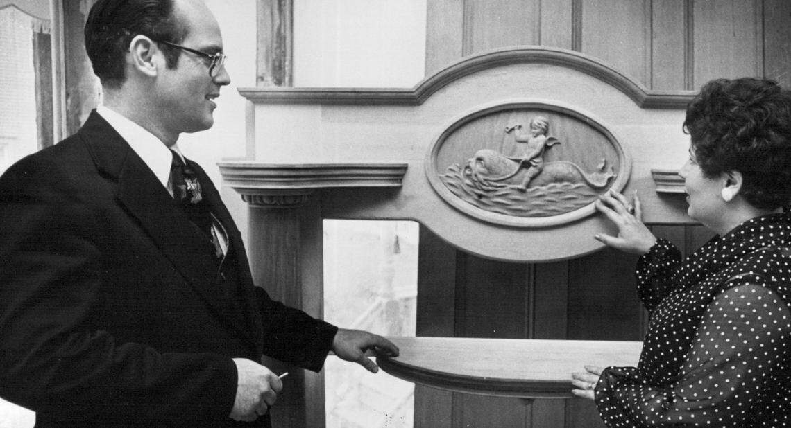 David and Sally Dewey are pictured inside the Sternberg Mansion in 1978 with an original mantle sculpture of a boy riding a sea creature. The carving has since been stolen, but new owner Pepin Suter filled the empty space with a different antique carving.