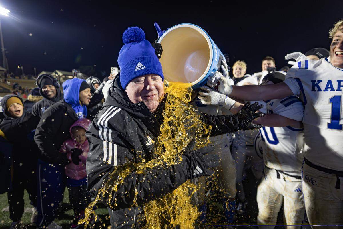 Kapaun head coach Weston Schartz is given a ceremonial Gatorade bath after Schartz led Kapaun Mt. Carmel to the 4A state title on Saturday. This was Schartz’s first state championship in nearly 40 years of coaching. Kapaun defeated Bishop Miege 56-21.