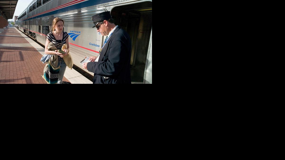 Heartland Flyer conductor Doug Berge checks passenger Candy Hart’s ticket to Oklahoma City.

