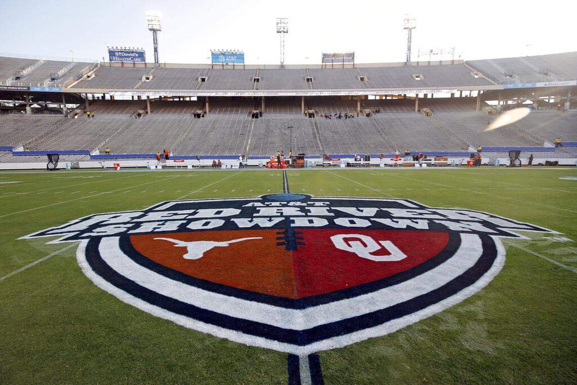 FILE - In this Oct. 10, 2020, file photo, The Red River Showdown logo is displayed on the field of the Cotton Bowl, prior to an NCAA college football game between the University of Texas and Oklahoma, in Dallas. Texas and Oklahoma made a request Tuesday, July 27, 2021, to join the Southeastern Conference — in 2025 —- with SEC Commissioner Greg Sankey saying the league would consider it in the “near future.” (AP Photo/Michael Ainsworth, File)